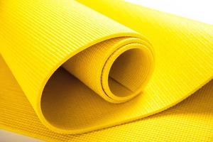 Closeup of yellow fitness mat photo