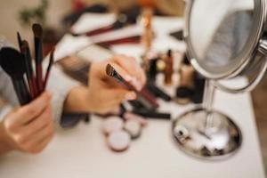 Female hands with makeup brushes photo