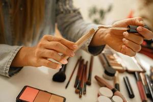 Female hands with tube of liquid concealer photo