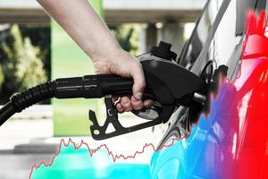 Hand with fuel nozzle and rising chart showing gasoline price increase during energy crisis photo