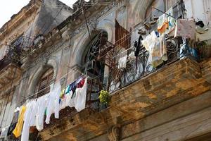 Laundry drying on an old shabby balcony photo