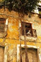 Old overgrown residential building in Havana city photo