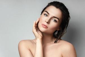 Young and beautiful woman with wet body and hair photo