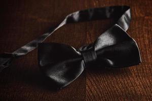 Bow tie on wooden table photo