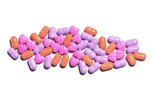 Closeup shot of a pile of colorful pills on white background. photo