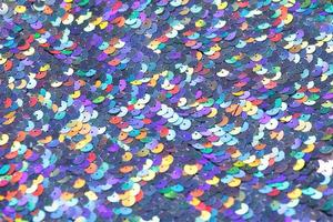 Closeup shot of a shiny multicolored sequin fabric. photo