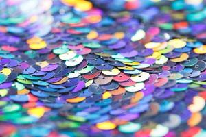 Closeup shot of a shiny multicolored sequin fabric. photo