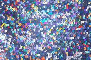 Closeup shot of a shiny multicolored sequin fabric. photo