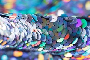 Closeup shot of a shiny multicolored sequin fabric. photo