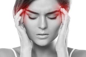 Woman with a source of red painful headache photo