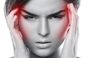 Woman with a source of red painful headache photo