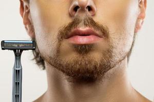 Man with unkempt beard before a shaving routine photo