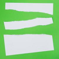 Torn paper on green background photo