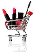 Shopping trolley with make-up products inside photo