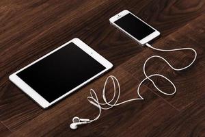 Smartphone and tablet with earphones photo