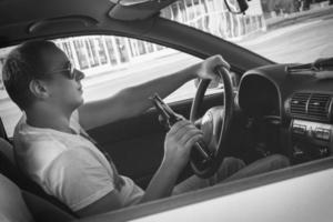 Man is drinking beer in his car photo