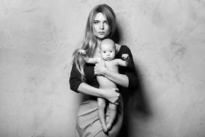 Beautiful well dressed and luxury mother with her cute baby boy photo
