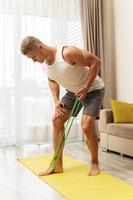 man during home workout with a resistance rubber bands photo