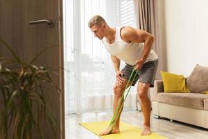 man during home workout with a resistance rubber bands photo