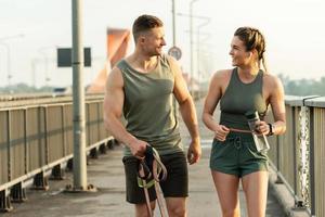 Happy athletic couple after fitness workout walking on a street photo