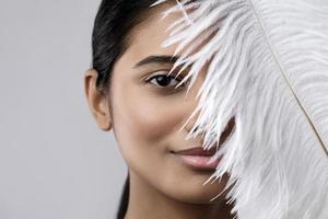 Young and sensual Indian woman with a soft ostrich feather photo