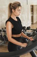 Athletic woman on the treadmill during her fitness workout photo