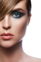 Sexy model in stylish image with sleek hair covering one eye and beautiful green eyeshadows on another photo