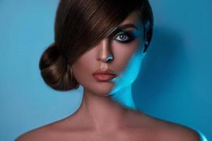 Model in stylish image with sleek hair covering one eye and beautiful green eyeshadows on another photo