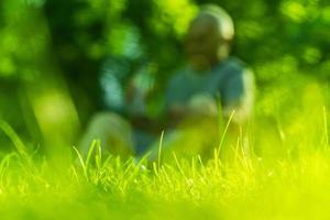 Green grass with a person out focus on background photo