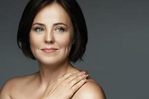 Beautiful middle aged woman with clean wrinkled skin photo