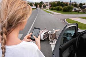 Driver makes 112 emergency call after a car accident with baby pram on the crosswalk photo