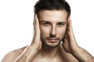 Portrait of young handsome man with wet face photo