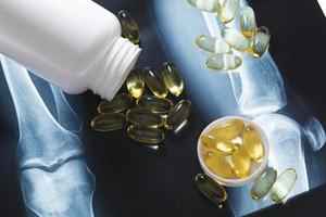 X-ray image and jar with fish or krill oil capsules photo