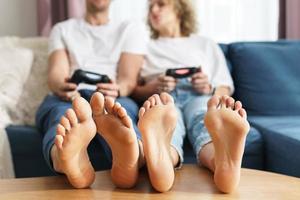 Couple with a gamepads are playing video game console photo