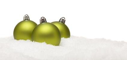 Green Christmas Ornaments on Snow Flakes Isolated on White photo
