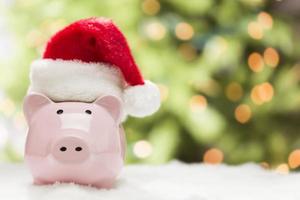 Pink Piggy Bank with Santa Hat on Snowflakes photo