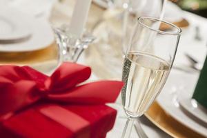 Christmas Gift with Place Setting at Table photo