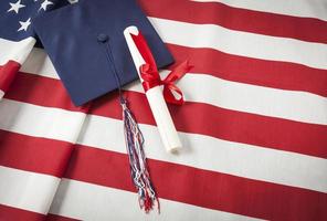 Graduation Cap and Diploma Resting on American Flag photo