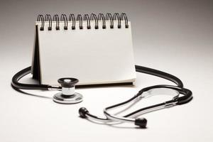 Blank Spiral Note Pad and Black Stethoscope photo