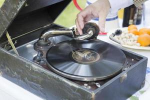 Man Starting Antique Phonograph Record Player photo