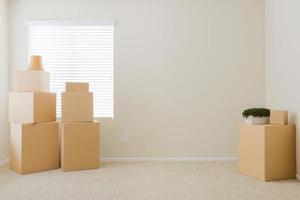 Variety of Packed Moving Boxes In Empty Room photo
