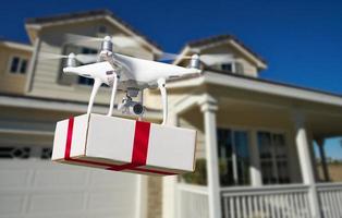 Unmanned Aircraft System Drone Delivering Box With Red Ribbon To Home photo