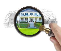 Hand Holding Magnifying Glass Revealing Finished House Build Over Drawing photo