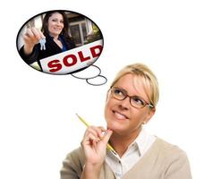 Woman with Thought Bubbles of Agent Handing Over New Keys photo