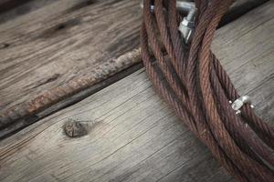 Abstract Rusty Iron Cable Laying on Old Wood Planks photo