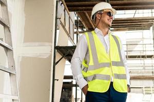 Architect wearing safety vest on a construction site photo