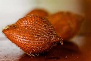 Closeup of salak or snake fruit on wooden table photo