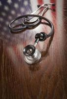 Knotted Stethoscope with American Flag Reflection on Table photo