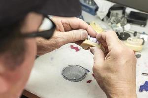 Dental Technician Working On 3D Printed Mold For Tooth Implants photo