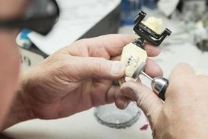 técnico dental trabajando en un molde impreso en 3d para implantes dentales foto